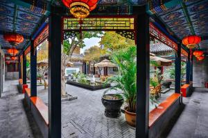 a building with a patio with plants and lights at Hotel Cote Cour Beijing in Beijing +226 photos