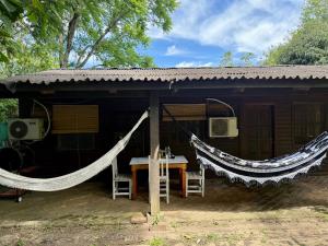 a small hut with a hammock in front of it at Casa Nani in Ituzaingó