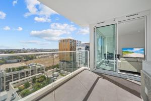 Cet appartement dispose d'un balcon offrant une vue sur la ville. dans l'établissement SOP 27 Stylish and Cozy 2 Bedroom Apartment, à Sydney