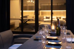 a table with glasses and a bottle of wine on it at 淡路島 Villa Paddle - Self Check-In Only in Sumoto