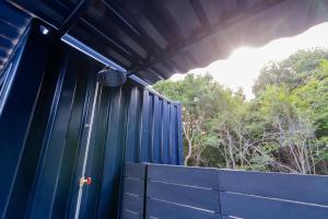 a blue building with a blue fence and trees at 淡路島 Villa Paddle - Self Check-In Only in Sumoto