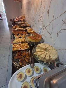 a buffet line with many different types of food at Pousada LuMar Maragogi in Maragogi