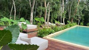 a swimming pool sitting next to a wooden deck at Chic apartment in Aldea Mayab with Lagoon access and private splash pool in Xul-Ha