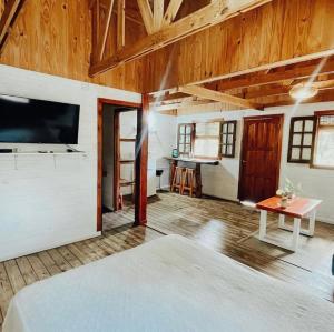 a bedroom with a bed and a tv in a room at Cabañas Parana Ranch in Ituzaingó