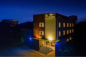 a building with a sign on the side of it at night at HOTEL TEN SQUARE - 5 Minutes from The Taj Mahal in Agra