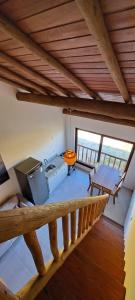 a room with a staircase with a table and a stove at Flat Manaí 02 in Marau +4 photos