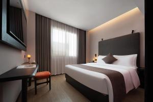 Ένα ή περισσότερα κρεβάτια σε δωμάτιο στο 广州栢里酒店北京路上下九步行街店