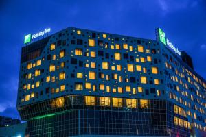 a building with lights on top of it at night at Holiday Inn Gwangju by IHG in Gwangju