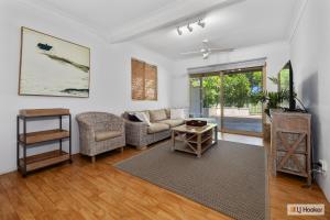 a living room with a couch and a table at Classic Beach House on Surfside - Pet Friendly in Pottsville
