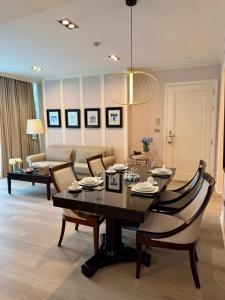a living room with a table and chairs and a couch at Rongratana Executive Residence Bangkok in Bangkok +8 photos