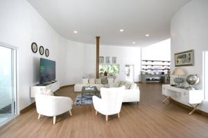 a living room with white furniture and white chairs at Tropical Garden Luxury Villa, Koh Phangan in Koh Phangan