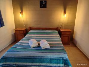 Ένα ή περισσότερα κρεβάτια σε δωμάτιο στο Cabañas Las Glicinas