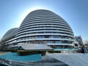a large building with a sign in front of it at New Jinshan Apartment in Beijing