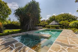 an image of a swimming pool in a yard at Auregi Villas - 2 and 3 bedroom near Diani Beach in Diani Beach