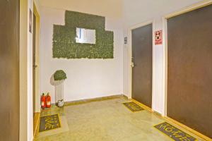 a room with a hallway with a plant on the wall at FabHotel Charvi Reemz in Anjuna +21 photos
