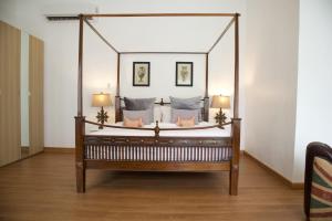 a canopy bed in a room with two lamps at Tropical Garden Luxury Villa, Koh Phangan in Koh Phangan +43 photos