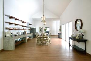 a dining room with a table and chairs in a room at Tropical Garden Luxury Villa, Koh Phangan in Koh Phangan