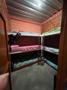 a small room with two bunk beds in it at Villa Lolita in Palmaseca