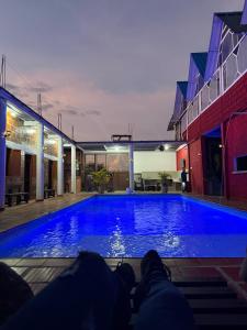 a person laying on the steps in front of a swimming pool at Villa Lolita in Palmaseca