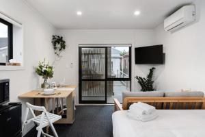 a living room with a bed and a table and a couch at Studio Unit 5 Mins Walk to CBD in Gisborne