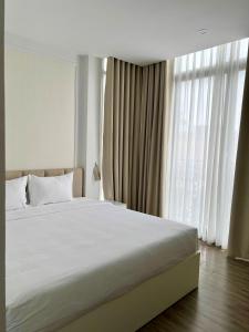 Postel nebo postele na pokoji v ubytování The Serenity Residence Ha Noi
