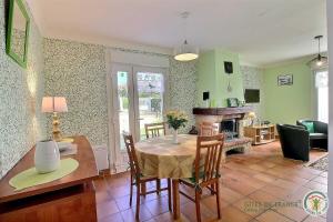 a kitchen and dining room with a table and chairs at Le jardin in Plestin-les-Grèves