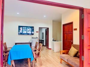 a living room with a blue table and chairs at Samui Tonggad Resort in Koh Samui 