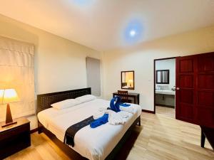 a bedroom with a bed with blue towels on it at Samui Tonggad Resort in Koh Samui  +109 photos