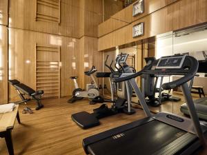 a gym with several exercise bikes and a treadmill at l'Echiquier Opéra Hotel Paris - MGallery Collection in Paris