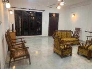 a living room with several chairs and a couch at Srimali in Pelena