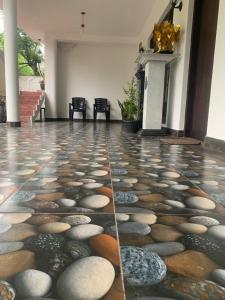 a room with a stone floor with rocks on it at Srimali in Pelena