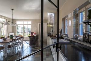 a kitchen with a table and a dining room at B&B Vinedo in Zele