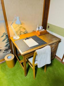 a desk with a lamp on top of it at 農家民宿と古民家カフェ 里山のカフェ ににぎ in Oga +65 photos