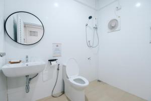 a bathroom with a sink and a toilet and a mirror at Peaceful 2BR Home Walk to Halal Street Food in Hat Yai +22 photos
