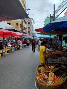 a group of people walking around an outdoor market at Peaceful 2BR Home Walk to Halal Street Food in Hat Yai