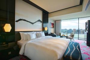 a hotel room with a large bed and a large window at Espacio Nagoya Castle, The Leading Hotels of the World "LHW" in Nagoya