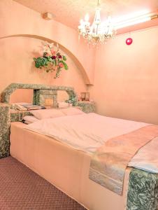 Voodi või voodid majutusasutuse 南の楽園 toas +4 fotot