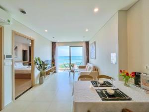 un salon avec une table à manger et une chambre dans l'établissement The Song Vũng Tàu Luxury Apartment, à Vung Tau