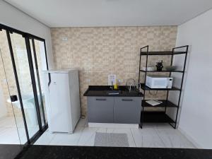 Kuchyň nebo kuchyňský kout v ubytování Sapucaia Flat - Apart Hotel