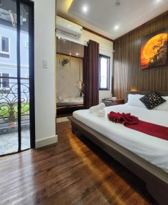 a bedroom with a large white bed and a bathroom at HA Hotel & Apartment in Vung Tau +62 photos