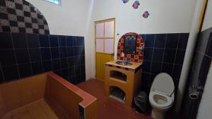 a bathroom with a toilet and a sink and a tub at Casita Paraiso Escondido in Peñita de Jaltemba