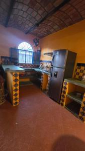 a kitchen with a stainless steel refrigerator and a table at Casita Paraiso Escondido in La Peñita de Jaltemba