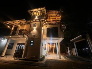 a house at night with a balcony on it at Mingu villa in Tangalle