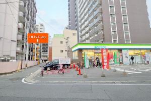 a car is parked in front of a car shop at OLIVE Stay in Fukuoka