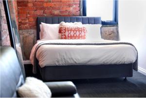 a bed with pillows on it in a room at Bayside House in Melbourne