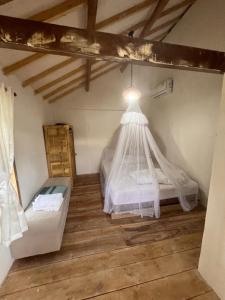 a bedroom with a bed with a mosquito net at Villa Lakdu in Sorongjukung +13 photos