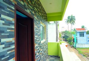 a door to a house with a colorful wall at RMP Home Stay in Puducherry