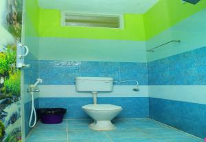 a bathroom with a toilet in a room at RMP Home Stay in Puducherry +24 photos