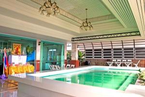 a large swimming pool in a room with a ceiling at Century Grand Hotel in Bung Kan