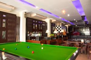 a pool table in a room with a bar at Century Grand Hotel in Bung Kan